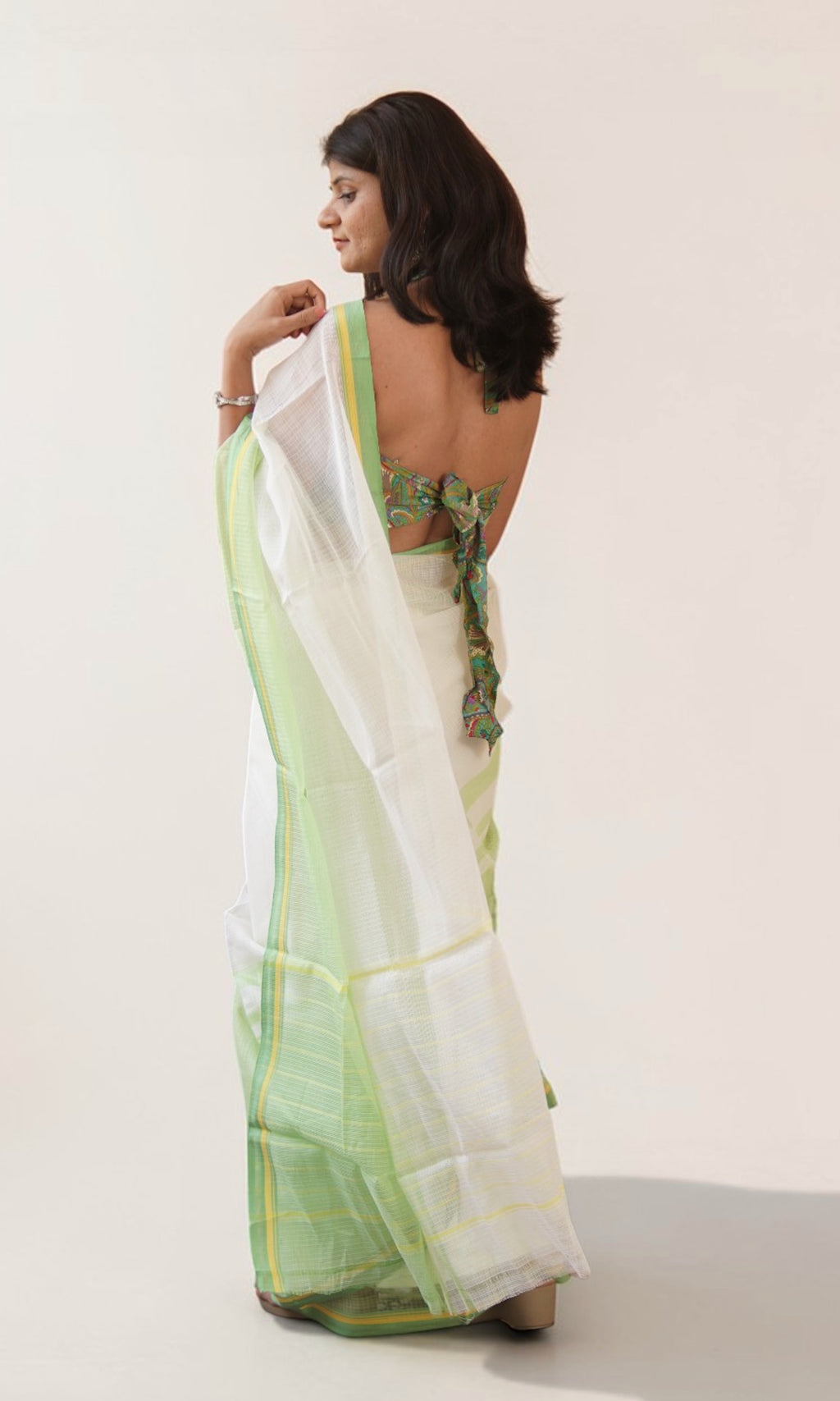 Pallu detail of off white Kota Doria saree with pastel green yellow border