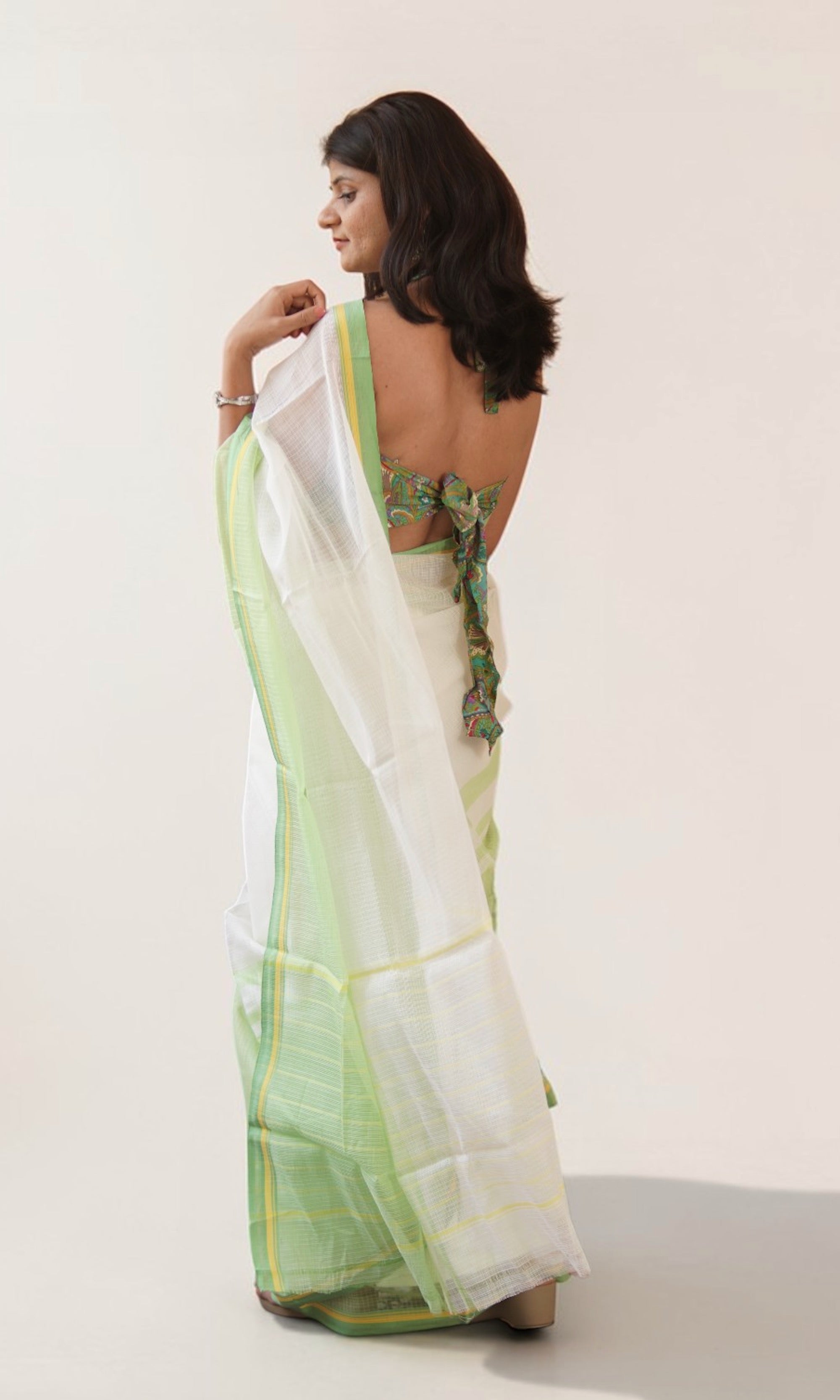 Pallu detail of off white Kota Doria saree with pastel green yellow border