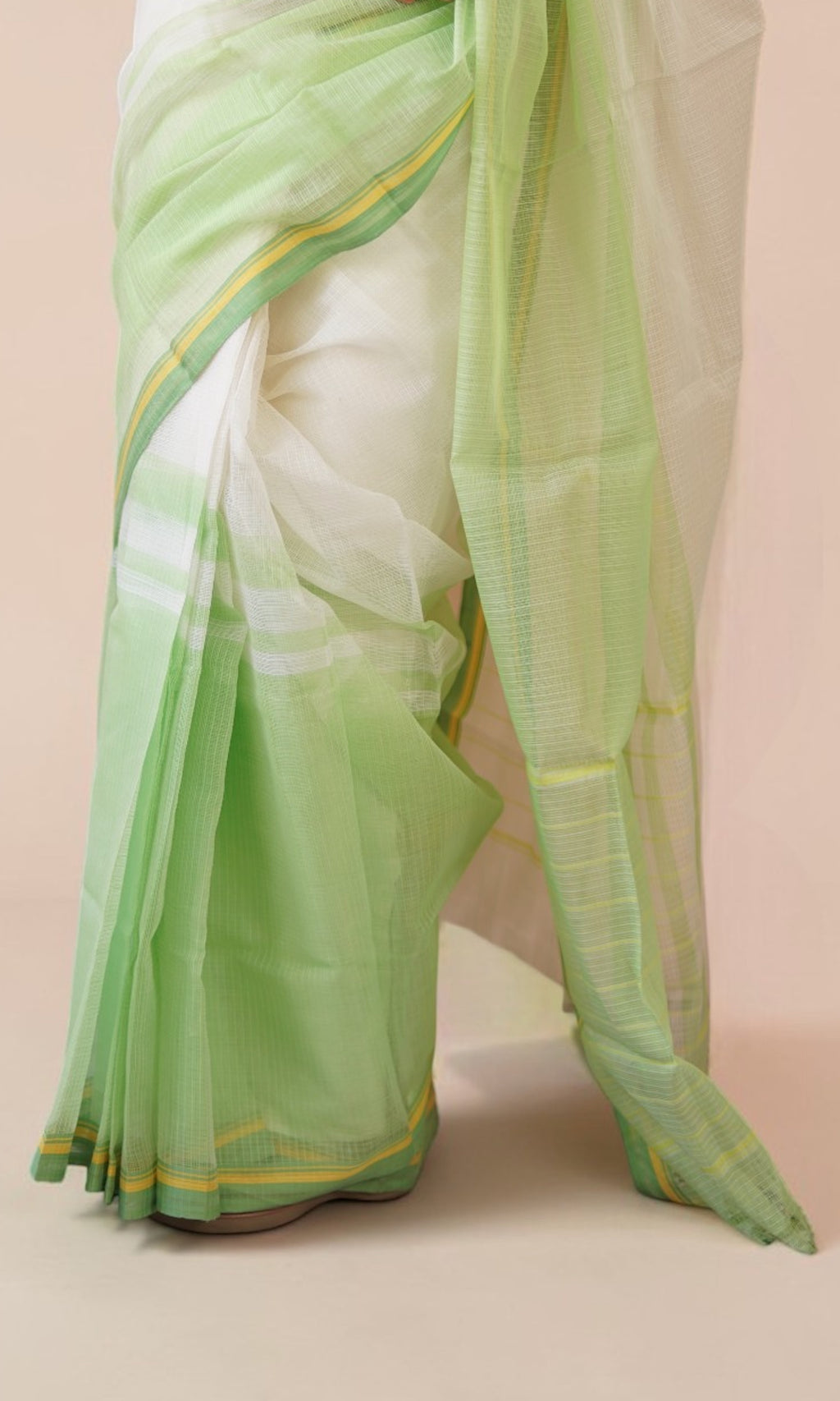 Pleats close-up of off-white Kota Doria saree with pastel green yellow border