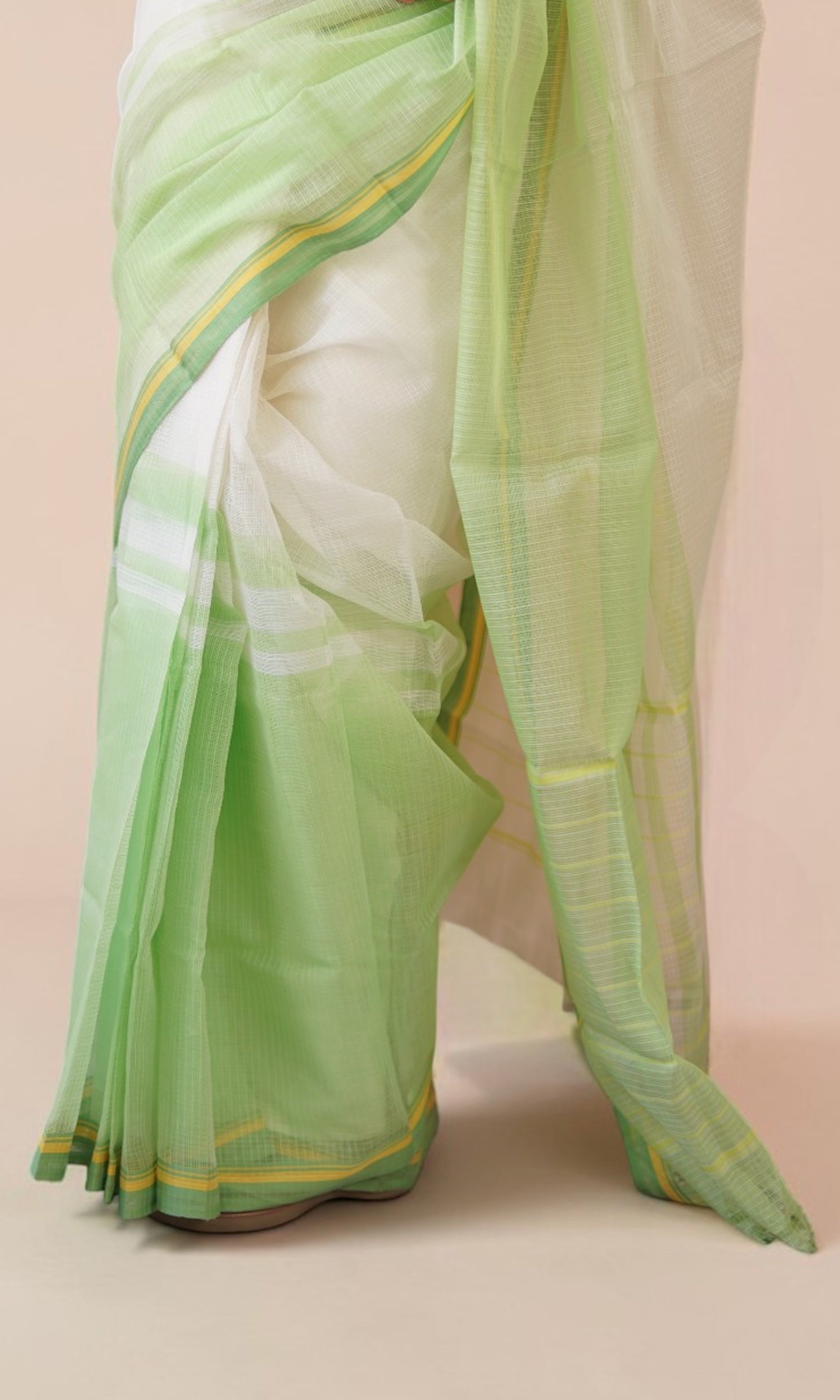 Pleats close-up of off-white Kota Doria saree with pastel green yellow border