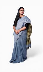 right full view of model wearing ash grey khadi cotton handloom saree from West Bengal.