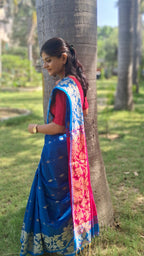 right view of a handwoven blue Shantipuri Tant saree with woven motifs and a contrasting red pallu.