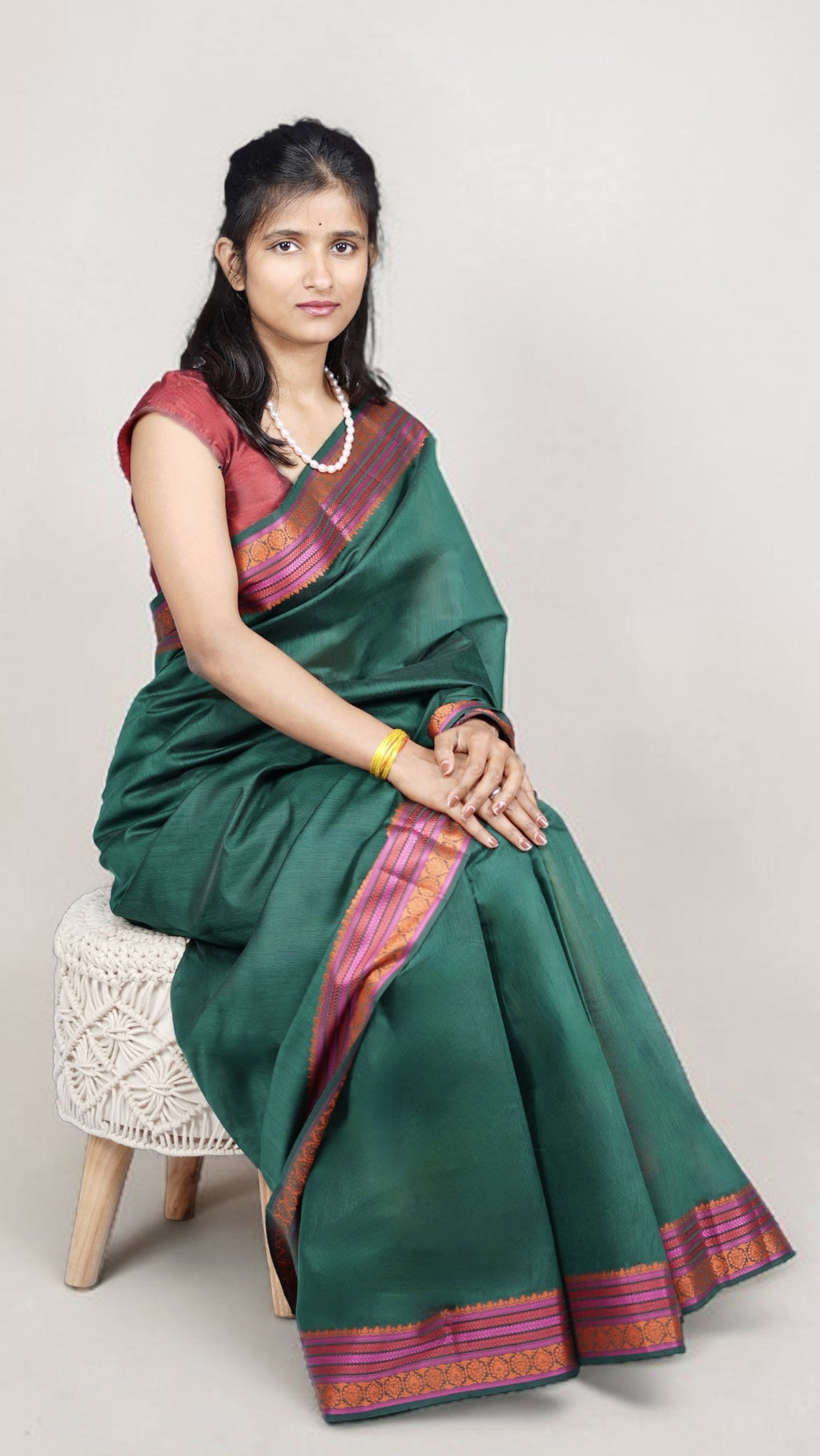 Left view of model draped in bottle green banaras cotton silk saree
