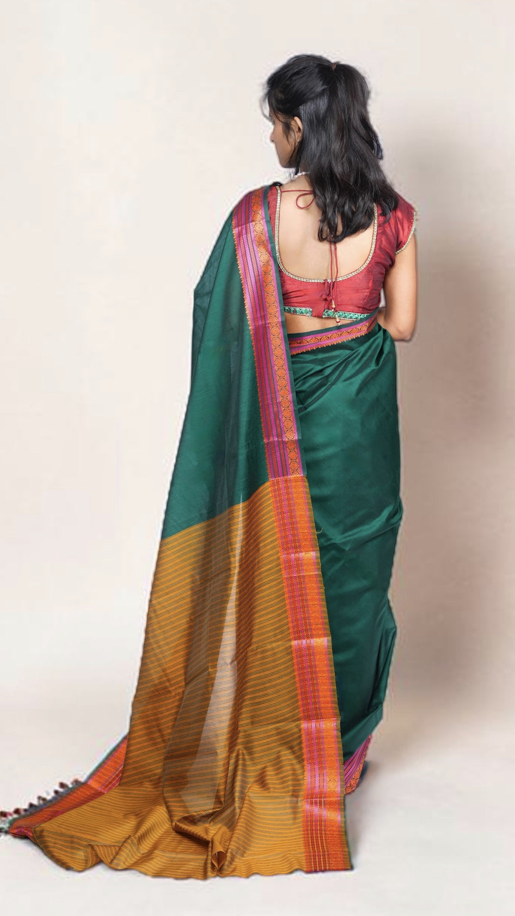 pallu details of model drpaed in bottle green banaras cotton silk saree