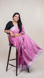 left side view of Handwoven magenta Kanjivaram silk saree with gold buttas and lavender zari border draped on model