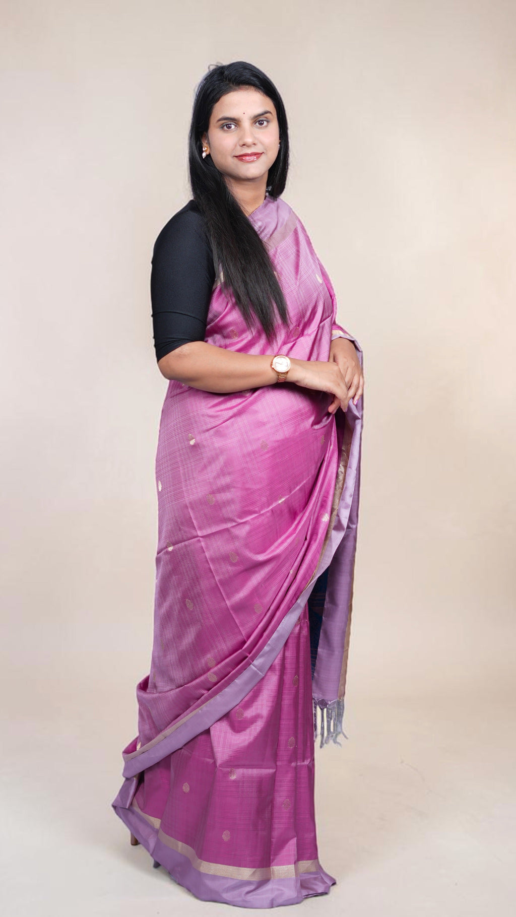 Handwoven magenta Kanjivaram silk saree with gold buttas and lavender zari border draped on model