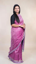 Handwoven magenta Kanjivaram silk saree with gold buttas and lavender zari border draped on model
