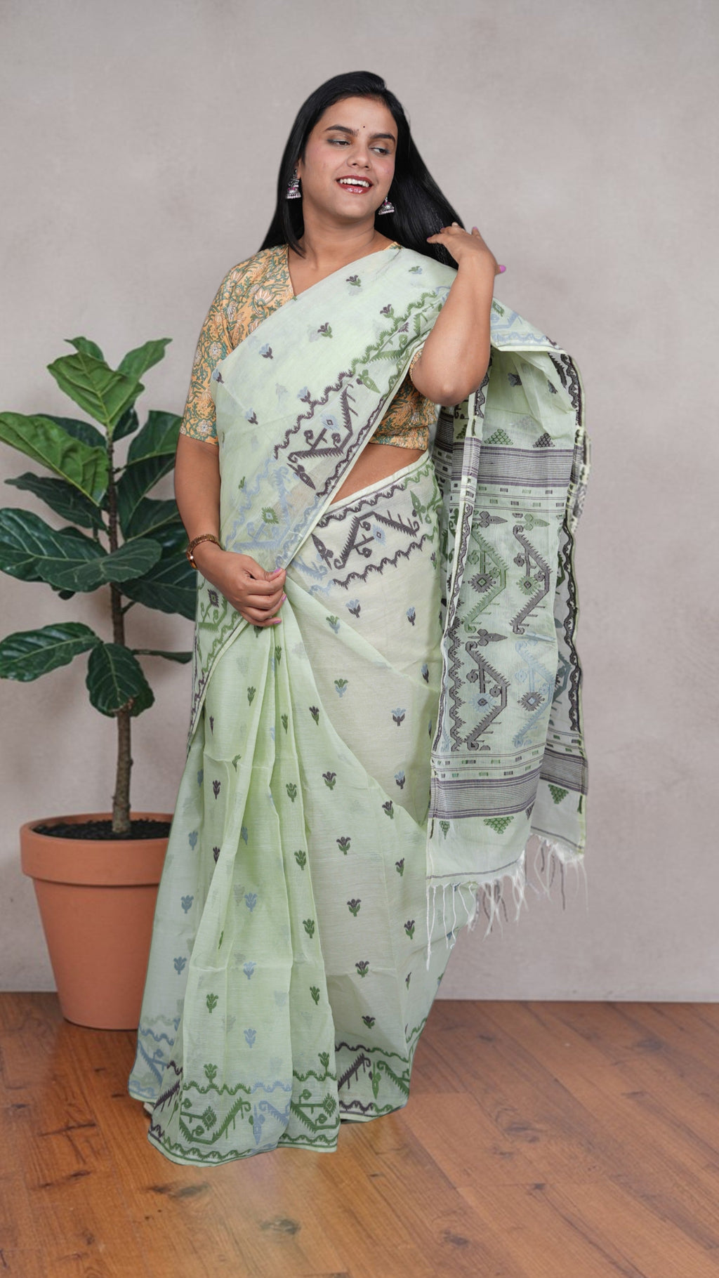 border details a mint green Baluchari Taant cotton saree with jacquard-woven motifs from West Bengal