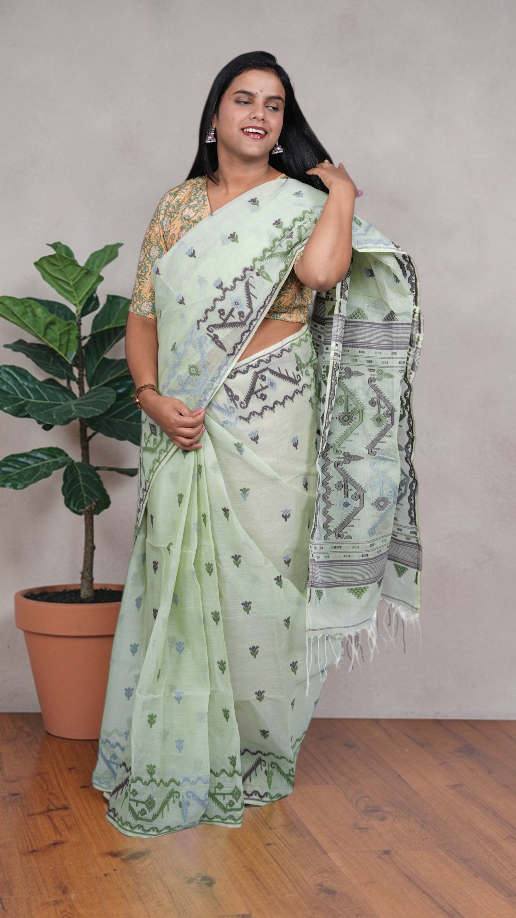 border details a mint green Baluchari Taant cotton saree with jacquard-woven motifs from West Bengal