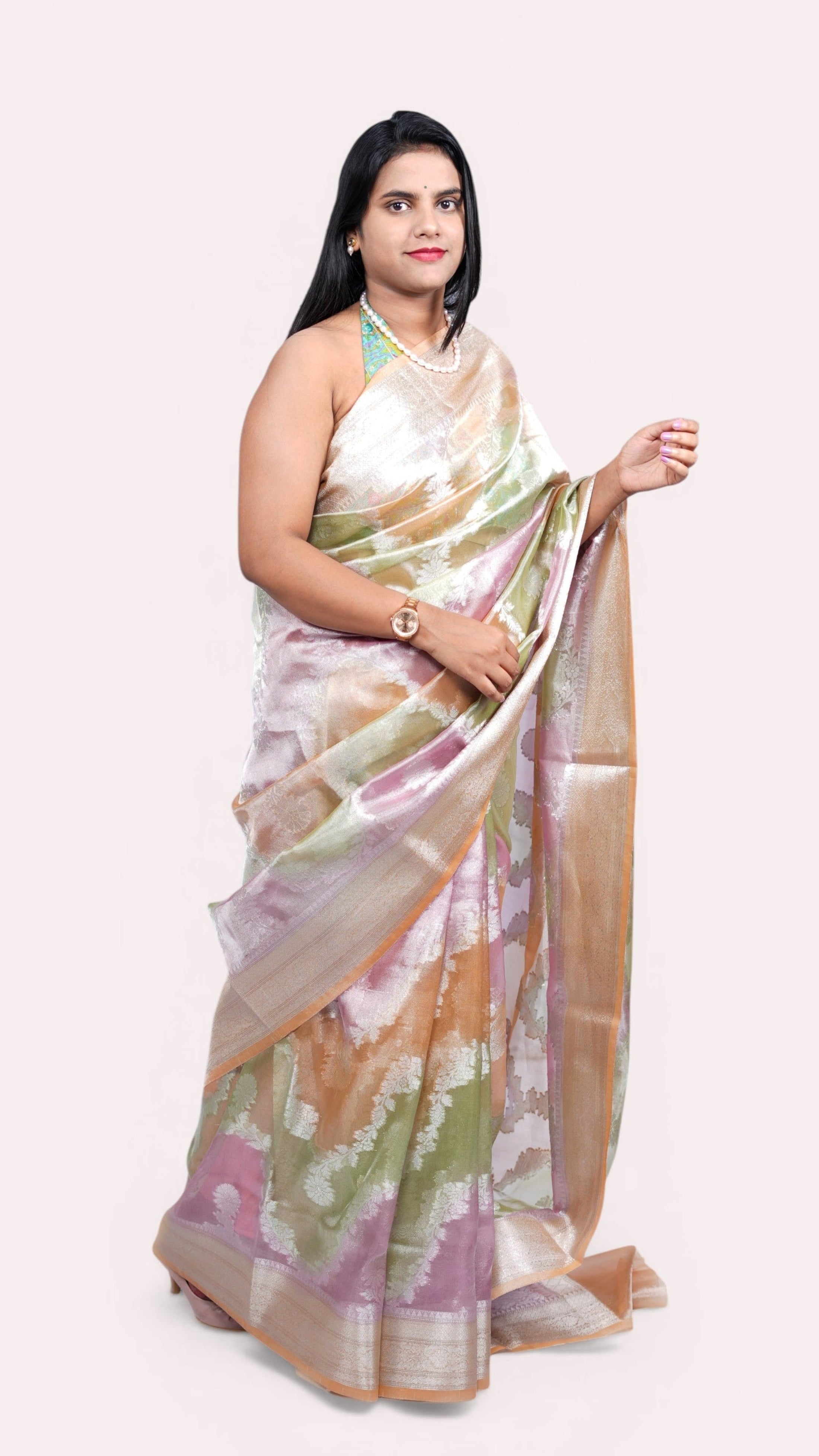Left view of model draped in pastel peach tissue rangkat banarasi saree.