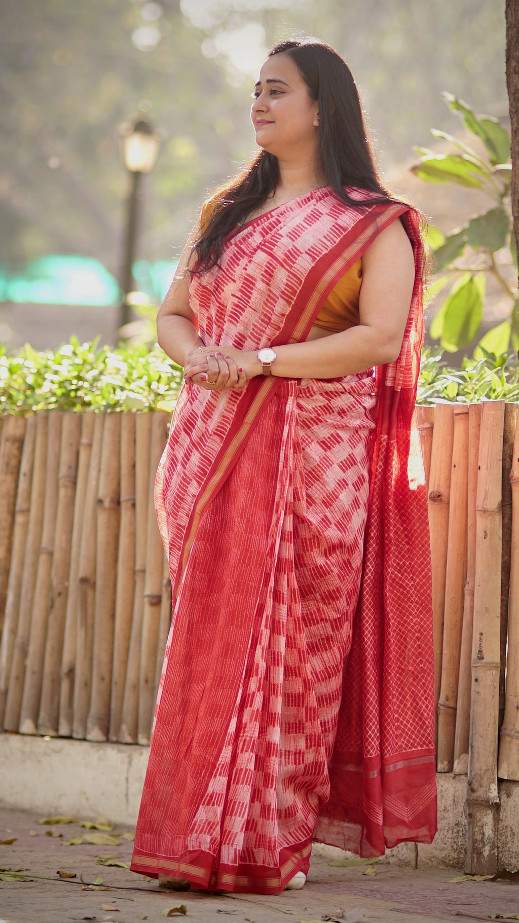 Red handeri cotton silk saree with Shibori work shown in full drape.