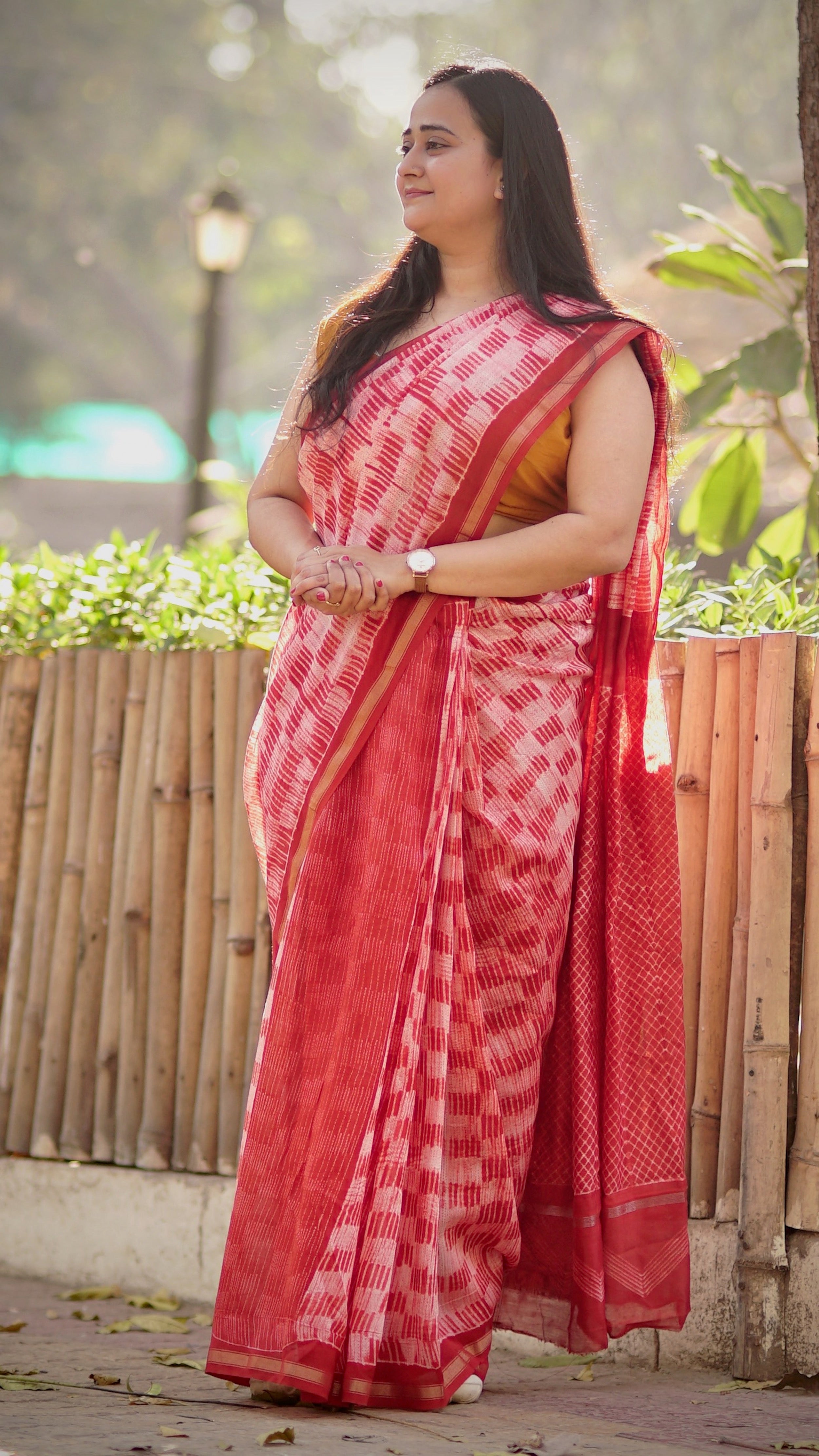 Red handeri cotton silk saree with Shibori work shown in full drape.